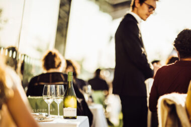 A bottle of Cloudy Bay Sauvignon Blanc at OXO Tower Restaurant London with awaiter in the background