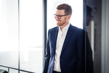 A man laughing in an office in London.