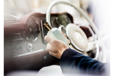 A bottle of Truefitt and Hill scent photographed in a classic car