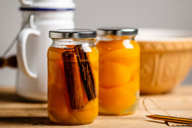 Jars of apricots and cinnamon on a wooden table by Richard Boll Photography. Nigel Slater Toast inspired image.