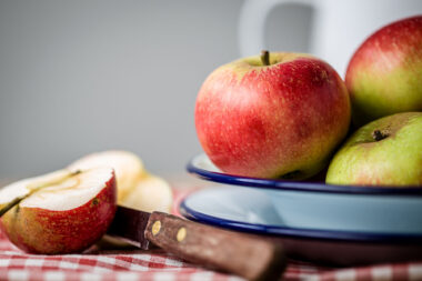 Food photography of apples on a plate for Holland Park School. Nigel Slater Toast inspired image.