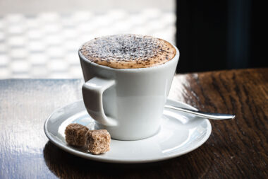 A cappuccino on a wooden table for a commission for Holland Park School in London.