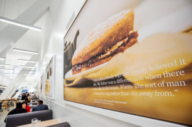 Interior of dining area of Holland Park School showing displayed food photography by Richard Boll. Nigel Slater quote from Toast.