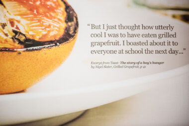 Close-up of text on a commissioned photograph of grilled oranges. Nigel Slater quote.