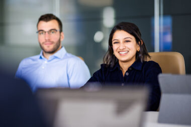Corporate lifestyle photograph of two people in a meeting in an office in Boston.