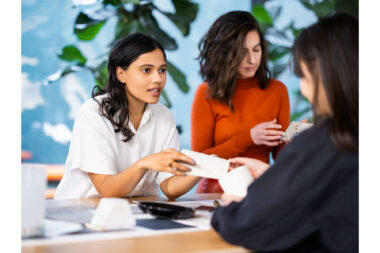 A lifestyle photograph of women discussing materials in a design studio in London.