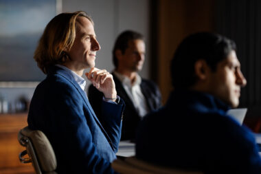 A man in a meeting in an office by Richard Boll Photography.