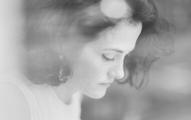 A portrait of the artist Marie Harnett drawing in a cafe in London.