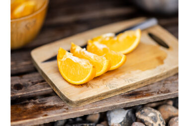 Slices of orange on a wooden board.