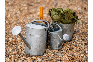 Watering cans containing cold water for use after people have been in a sauna on the beach.