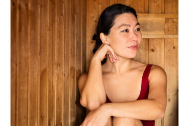 A woman relaxing in a sauna.