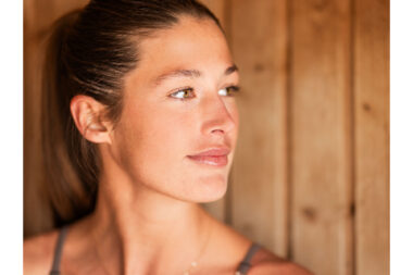 Close-up of a woman's face in a sauna.