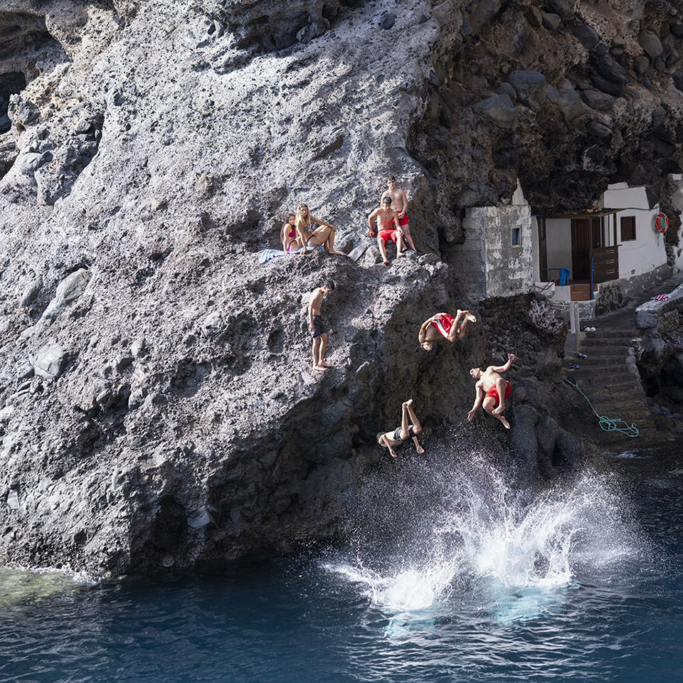 The photograph I see the boys of summer by Richard Boll depicting a scene in Spain of people leaping from a cliff into the sea.