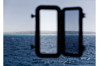 The view through a window in a diving boat cabin- lifestyle photography by Richard Boll.
