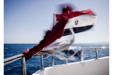 Laundry drying and a flag in the wind on a luxury diving liveaboard- luxury lifestyle photography by Richard Boll.