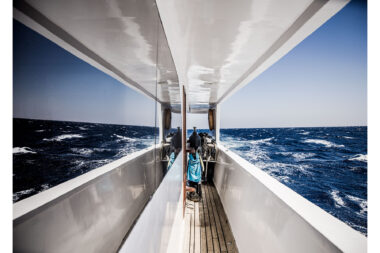 The sea reflected in the windows of a diving liveaboard boat called Sea Dragon - marine photography by Richard Boll.