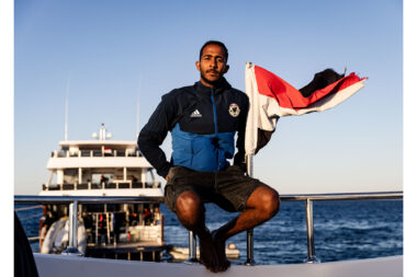 A man sat on the deck of a diving liveaboard in the Red Sea in Egypt- dive photography by Richard Boll.
