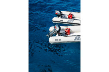 Two rigid inflatable boats lying beside a diving boat and the clear blue water of the Red Sea- marine lifestyle photography by Richard Boll.