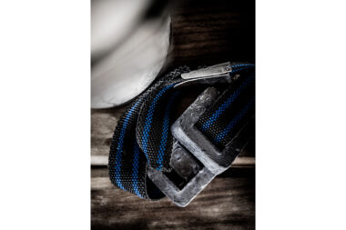Closeup photograph of a diving weight belt curled up on the deck of a dive boat - authentic diving lifestyle photography by Richard Boll.