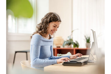 A lifestyle photograph of a woman playing an electric keyboard at home, photographed for ROLI by Richard Boll.